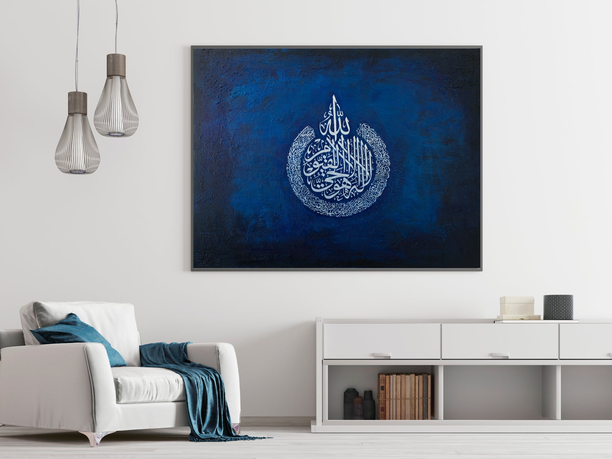 The Throne Verse by Sarwat Bano, an original textured painting of Ayat al-Kursi in silver calligraphy on deep blue, shown hanging above a sideboard